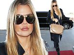 Khloe Kardashian showing up makeup powder and huge lips at LAX  sept 13, 2015 X17online.com